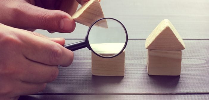 viewing in a magnifying glass the design of a house layout / inspection of construction objects