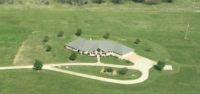 aerial view of large home on big piece of land