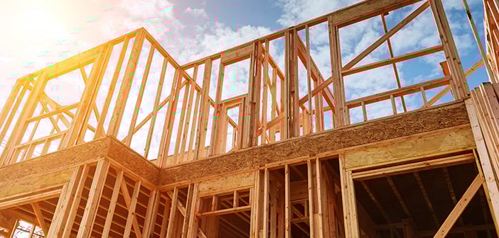home framing during home construction against cloudy sky