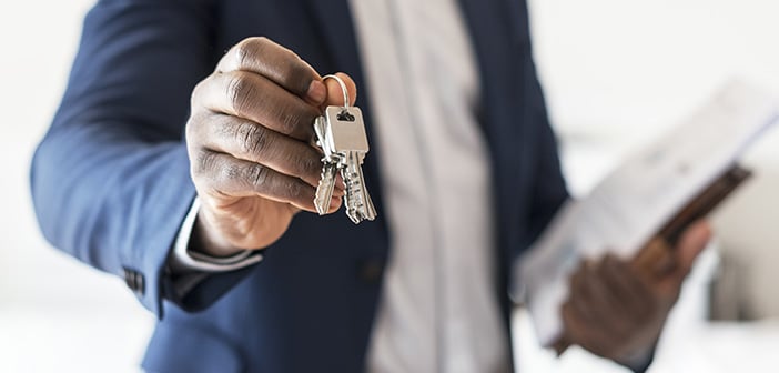 Real estate agent handing the house key