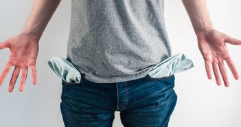 How to Stop Being Broke—Instantly male showing empty pockets implying moneyless