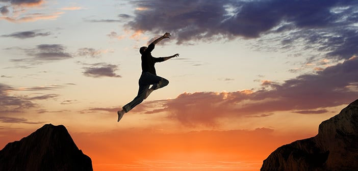 Man Leaping Mid-air on Mountainside