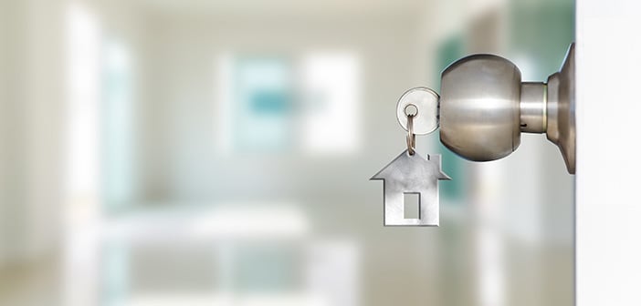 Open door with keys, key in keyhole