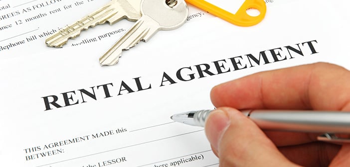 eental agreement form with signing hand and keys and pen