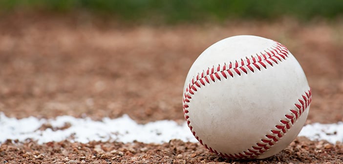 Close-up of a baseball sitting near the foul line