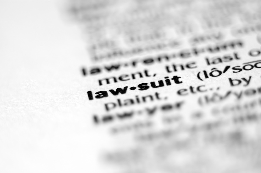 Extreme macro or close up of the word LAW-SUIT. Very shallow depth of field is intentional and shows only the word LAW-SUIT in focus.