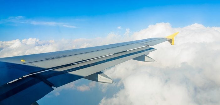 Airplane's wigs,flying above on clouds.