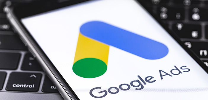 Google Ads logo on the display iPhone closeup on keyboard background. Google is the biggest Internet search engine in the world