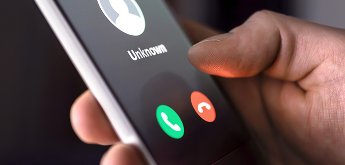 Phone call from unknown number late at night. Scam, fraud or phishing with smartphone concept. Prank caller, scammer or stranger. Man answering to incoming call. Hoax person with fake identity.