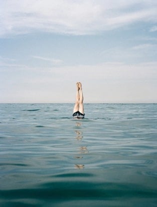person diving into ocean