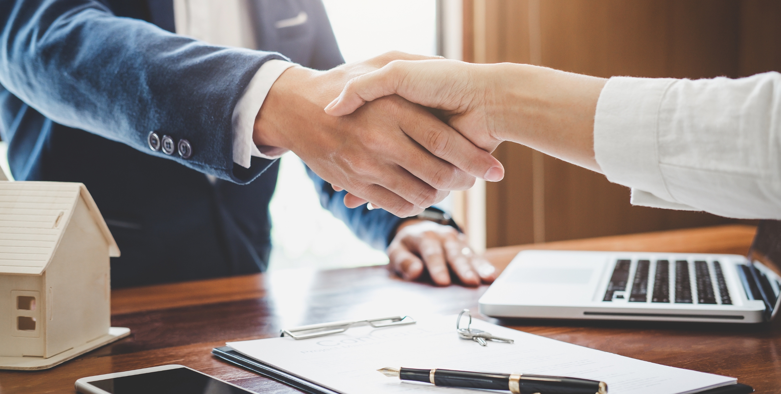 shaking hands on a multifamily real estate deal