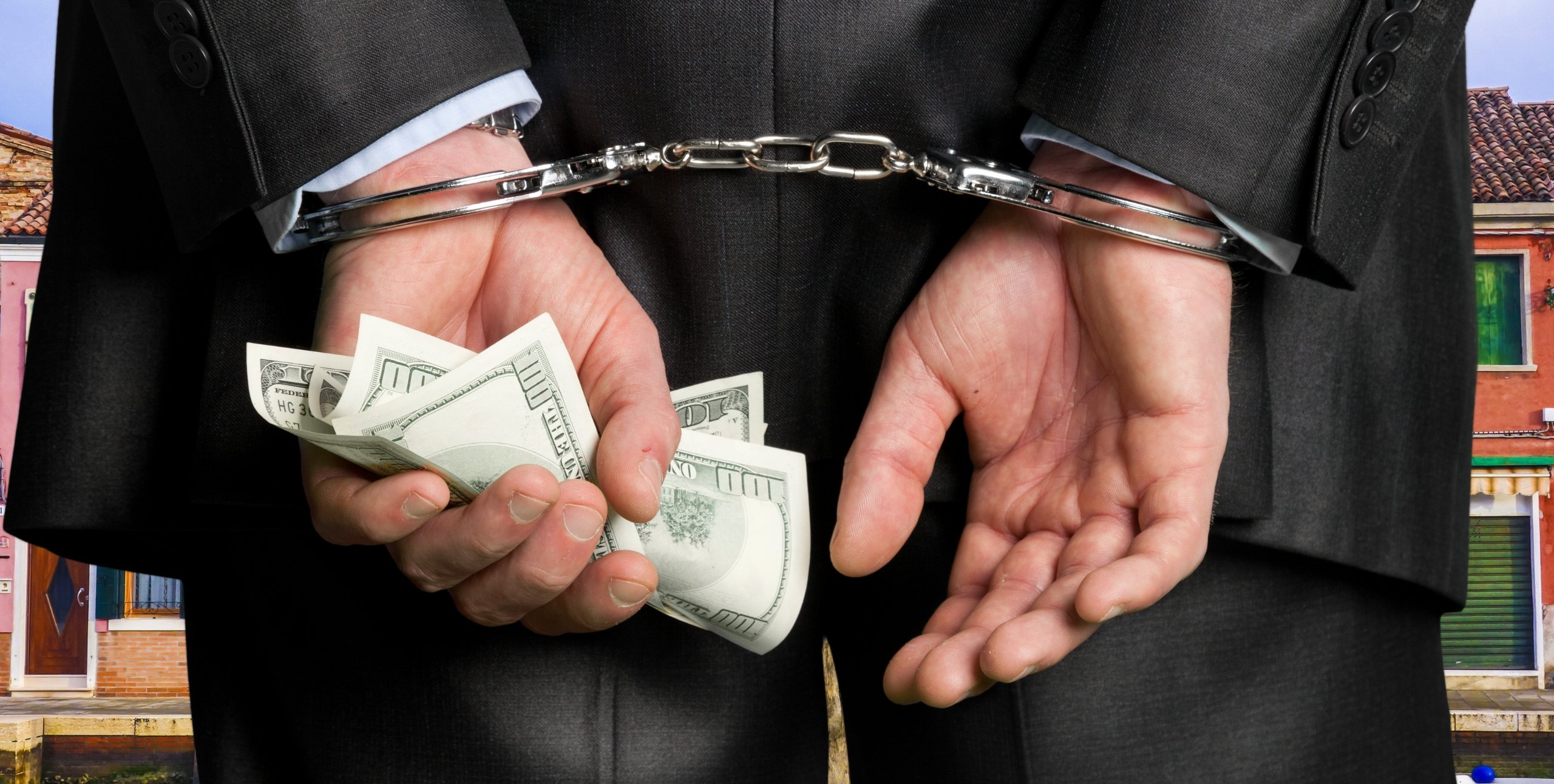 person in handcuffs for fraud