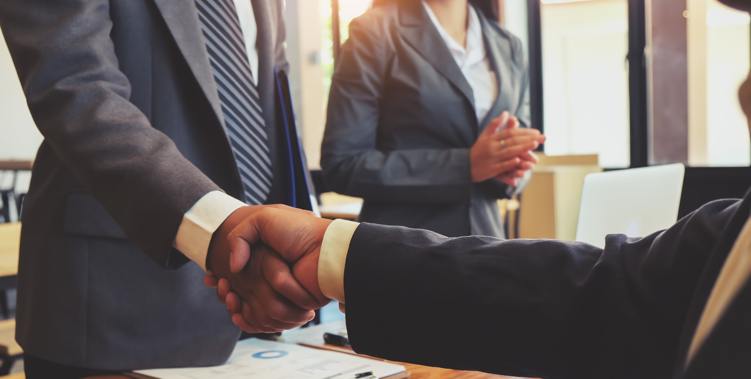 shaking hands to create real estate partnerships