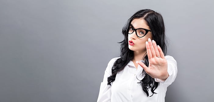 woman with hand extended out gesturing stop or rejection