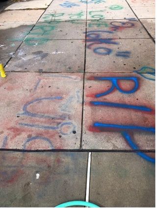 Graffiti on sidewalk paying respects to a deceased tenant